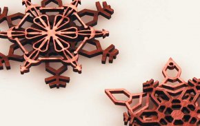 Laser cut snowflake cut from wood.
