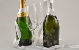 Laser engraving champagne bottles.