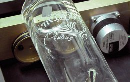 Laser etching a glass vase with an Epilog Laser System.